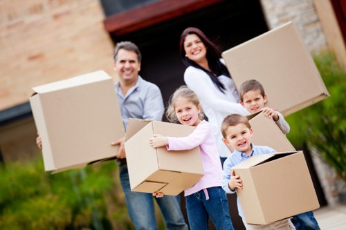 Professional movers handling boxes and furniture in West London