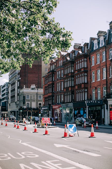 A street sign mounted on a beige stone building indicates 'Serle Street WC2' in the City of Westminster, with the sign partially shaded by a shadow cast by the building's upper structure. Below the st